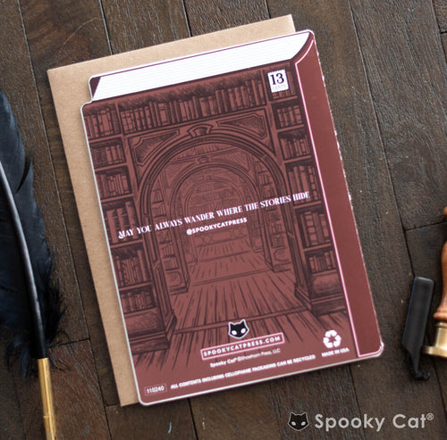 Ghost story birthday card shaped like a book, with a cake illustration and a haunted library background.