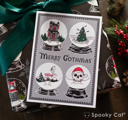 Merry Gothmas card with four spooky snow globes featuring haunted house, Christmas tree, skeleton bird, and skull in Santa hat. Perfect for Creepmas
