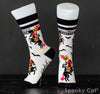 Side and front view of Sleepy Hollow-inspired Halloween socks showcasing the Headless Horseman holding a flaming pumpkin head, with black bats and bare trees on a cream background. Text on the cuff reads "Halloween Forever.