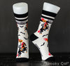 Angled view of Spooky Cat Press's Headless Horseman socks, showing the design of a pumpkin-headed rider on horseback, surrounded by bats. The sole features "Spooky Cat" branding. A bold Halloween sock design inspired by Sleepy Hollow.