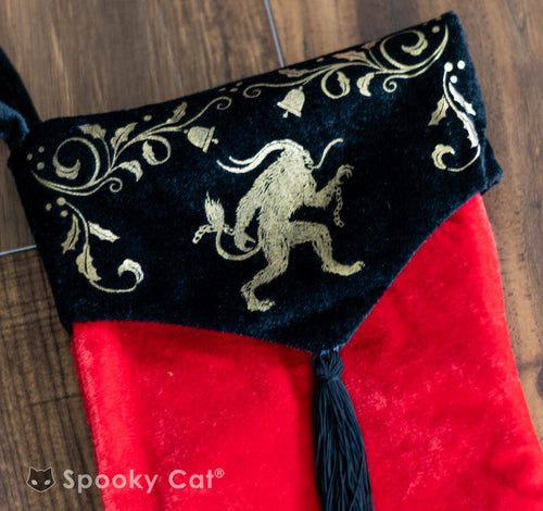Gothic Christmas stocking in red velvet featuring gold Krampus design