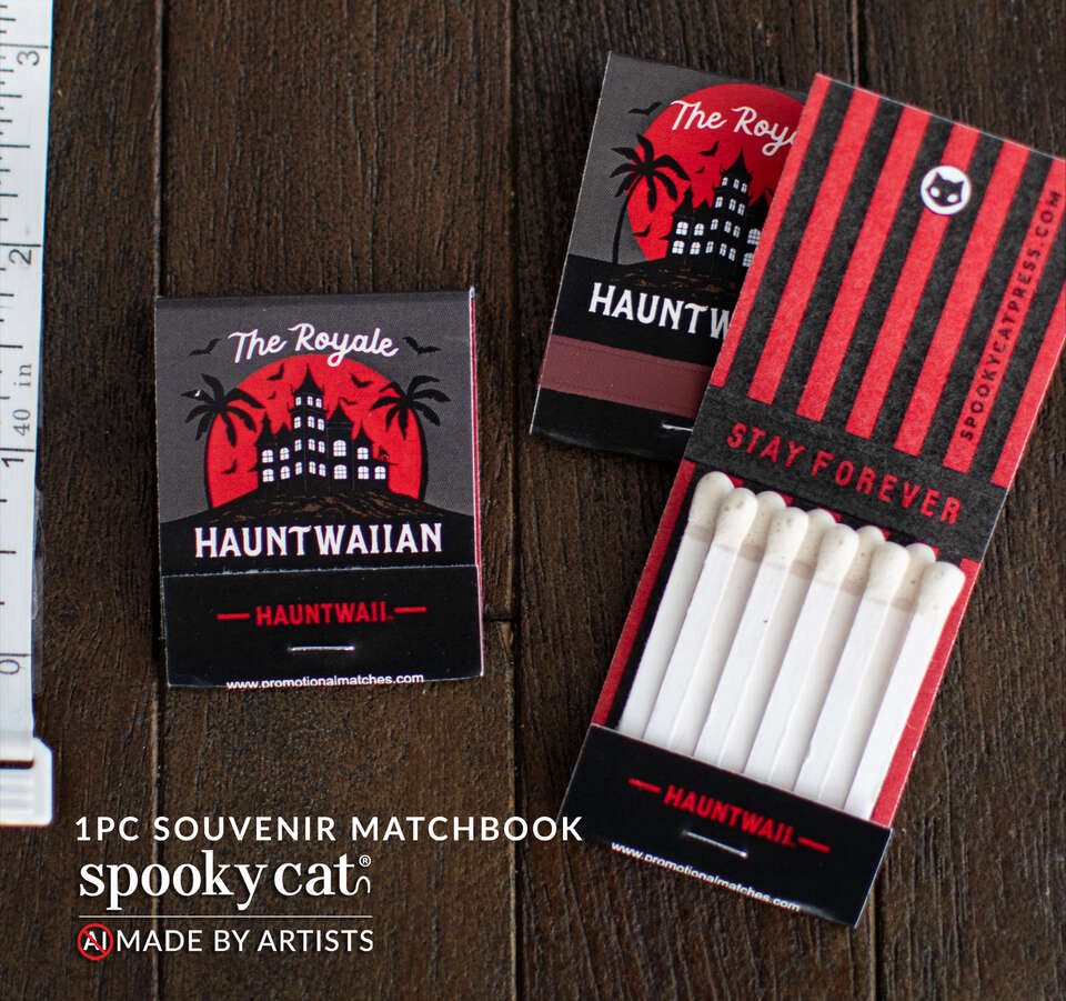Vintage-inspired souvenir matchbook featuring the Royale Hauntwaiian Hotel artwork with haunted resort silhouette, red moon, and safety matches.