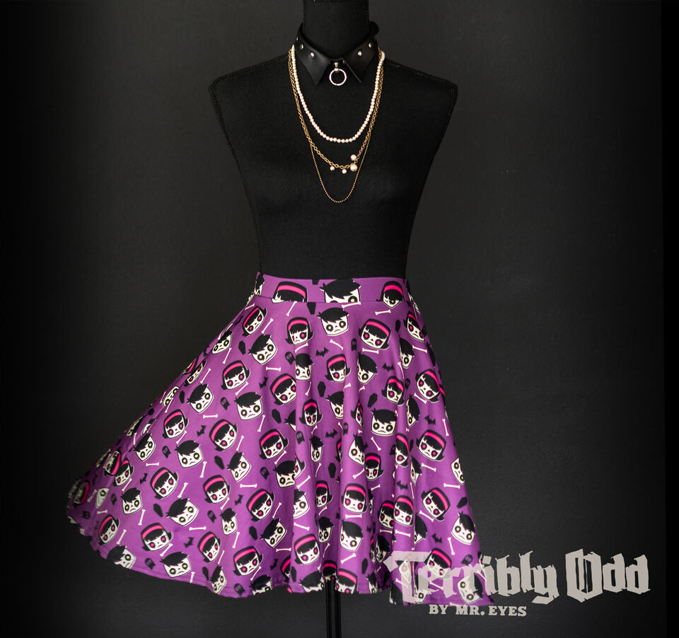 A dress form wearing a Terribly Odd Coffin Kid skater skirt featuring a boy and girl, bats, bones, and tombstones on a purple background. The Terribly Odd brand logo appears in the bottom right corner with the text NO AI, made by artists.