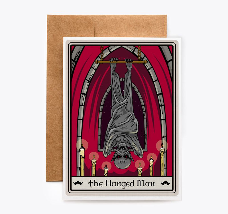 The Hanged Man tarot card from the Vampire Tarot deck, showing the figure suspended upside-down with a halo and a coin in hand.